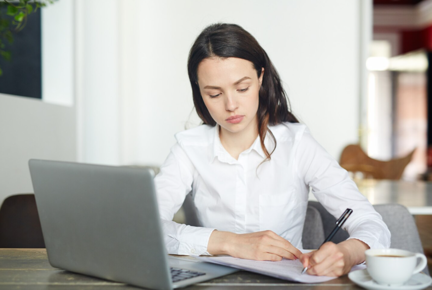 Young professional reviewing documents illustrating learning insurance basics in your 20s