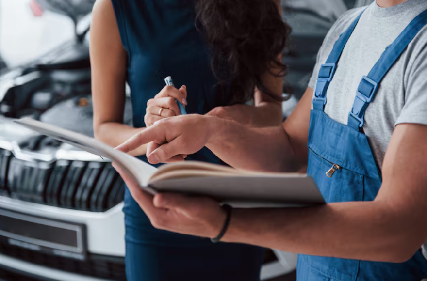 Mechanic reviewing repair estimate to decide when self-insurance makes sense