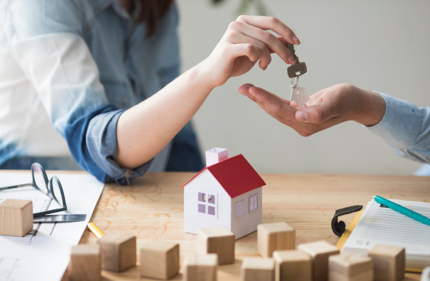 New homeowner receiving house keys while reviewing insurance checklist
