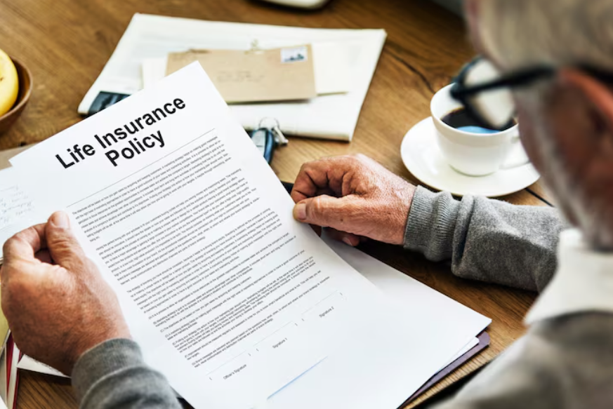 Reviewing life insurance document with insurance policy exclusions explained in fine print