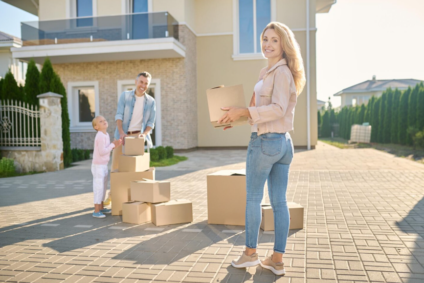 family moving into new house showing how major purchases affect insurance coverage