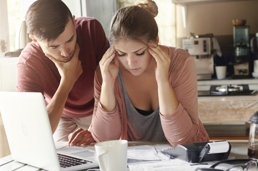 couple reviewing insurance bills during financial hardship and budget stress